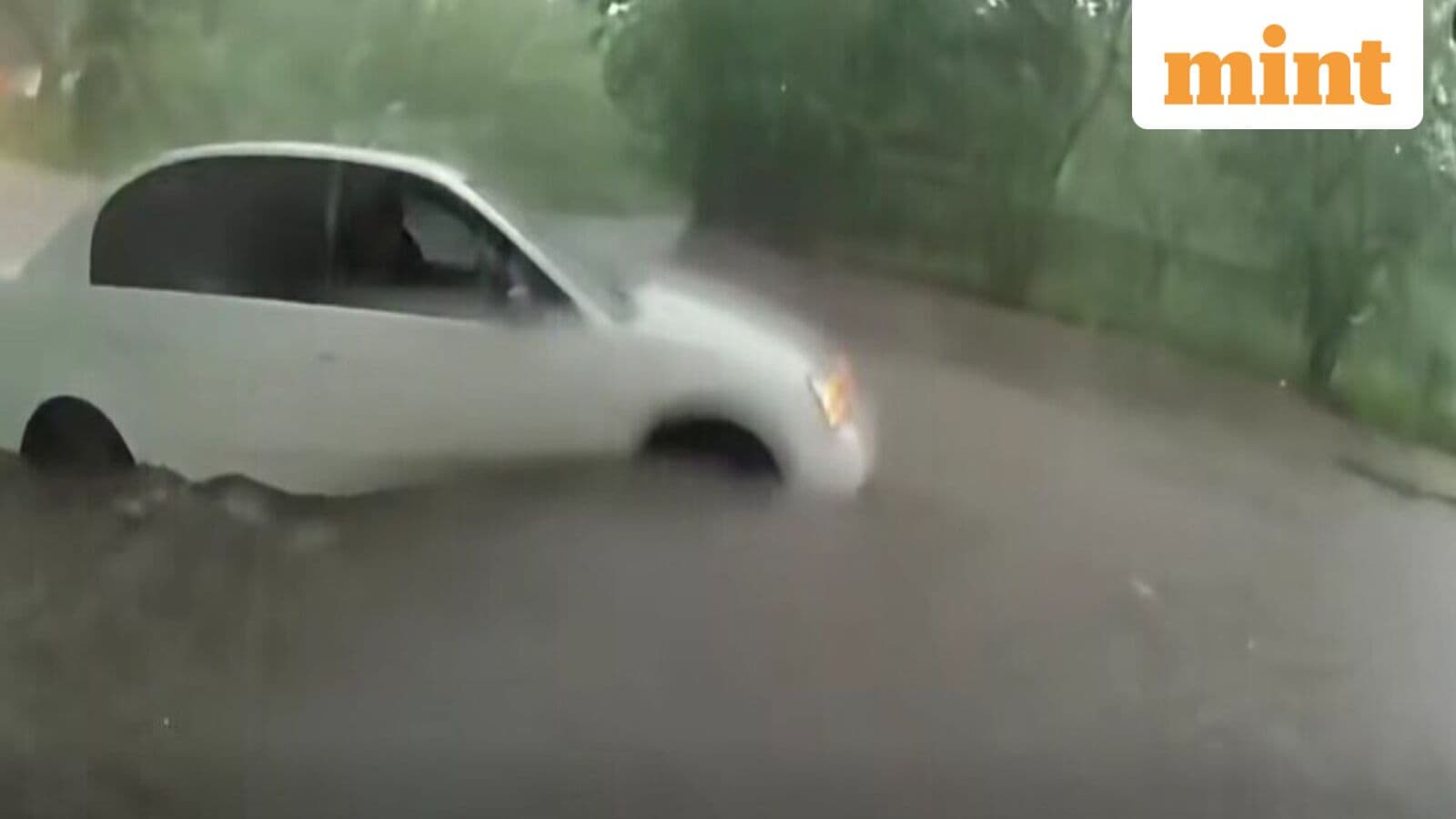 Texas police officers rush into raging floodwaters to save infant trapped inside car | Watch